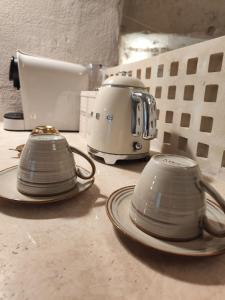 a group of plates and a toaster on a counter at Stone House in Matera +19 photos