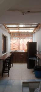 a kitchen with wooden cabinets and a brick wall at K-zona 70 in Medellín