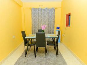 a dining room with a table and chairs at KaRa Homes in Kisii