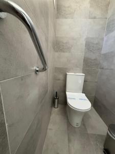 a bathroom with a toilet and a shower at Angeliki Beach Hotel in Megali Ammos