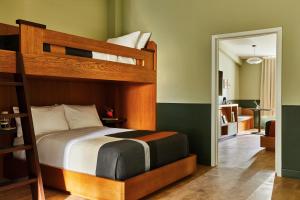 a bedroom with a bunk bed and a living room at The Outpost Rocky Mountains in Estes Park