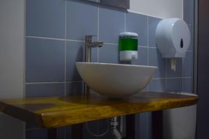 a bathroom sink with a soap dispenser on a counter at FILANDIA HOTEL in Filandia