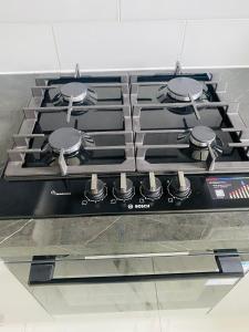 a stove top oven with four burners on it at New Malden, 3 Bedroom Guest House in Malden