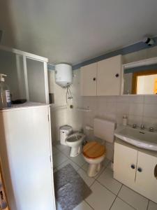 a bathroom with a toilet and a sink at LA GRAA in Piuro