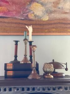 a shelf with candles and books on a table at Exceptional house on the waterfront in Reeuwijk