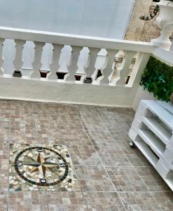 a staircase with a mosaic floor with a clock on it at B&B Antiche Mura in Sammichele di Bari