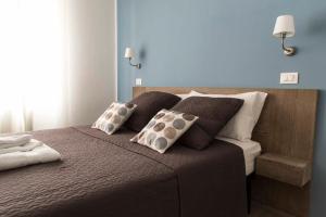 a bedroom with a bed with two pillows on it at La Casa Di Titti in Civitanova Marche