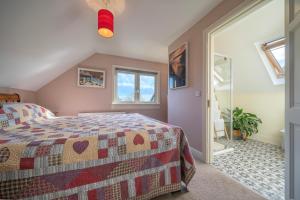 a bedroom with a bed and a window at The Bird House - Coastal Lodge in lovely Forest Setting nr. Kinsale in Cork