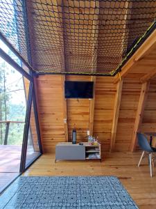 a room with a table in the center of a house at Arce Cabañas Mazamitla in Mazamitla