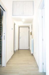 a hallway with white walls and a white door at Domus Etruria in Civitavecchia