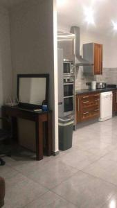 a kitchen with a table and a counter in it at 2 Bed Apartment in Gibraltar - Marina Views in Gibraltar