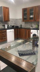 a kitchen with a glass counter top in a kitchen at 2 Bed Apartment in Gibraltar - Marina Views in Gibraltar