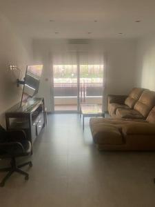 a living room with a couch and a piano at 2 Bed Apartment in Gibraltar - Marina Views in Gibraltar
