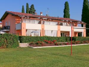 a house with a garden in front of it at La Fattoria Apartments in Lazise