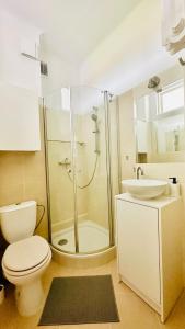 a bathroom with a shower and a toilet and a sink at Green&Comfy Apartment Żoliborz in Warsaw