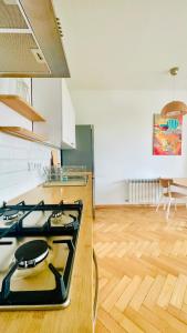 a kitchen with a stove top oven in a room at Green&Comfy Apartment Żoliborz in Warsaw