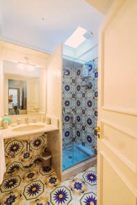 a bathroom with a sink and a shower at Casa Camerelle Luxury Apartment in Capri