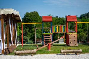 a playground with a slide and a play structure at Una Relax in Bosanski Novi