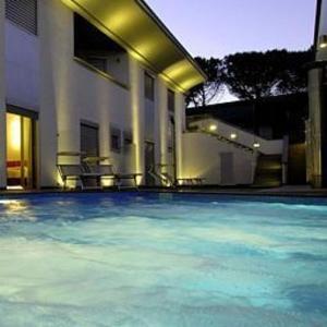 a large swimming pool in front of a house at Together Florence Urban Resort in Florence