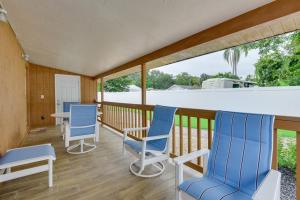 two blue chairs and a table on a porch at 10 Mi to Coquina Beach Spacious Bradenton Duplex in Bradenton