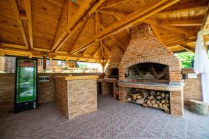 an outdoor kitchen with a large brick fireplace at Una Relax in Bosanski Novi