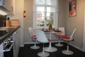 a kitchen with a table and chairs in a kitchen at Château La Fontaine - stylish accomodation - green environment in Mons