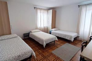 a room with three beds in a room at Altana Rooms Apartment in Koper