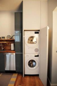 a kitchen with a washer and dryer in a kitchen at Trendy Studio in Prime South Philly Neighborhood in Philadelphia