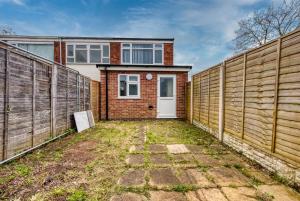 a house with a fence in front of it at Stylish 3Bedroom House in Prime Leicester Location in Humberstone