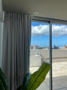 a room with a window with a view of the city at Hotel Ciudadano Suites in Montevideo