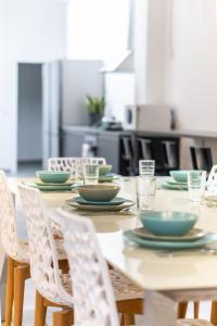 a table with chairs and plates on top of it at Apartment 34 in Derech Jaffa in Tel Aviv