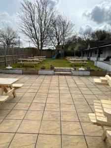 a group of picnic tables and benches in a park at The Malt Shovel Inn in Bridgwater