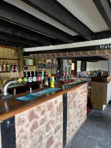 a bar in a restaurant with a brick wall at The Malt Shovel Inn in Bridgwater