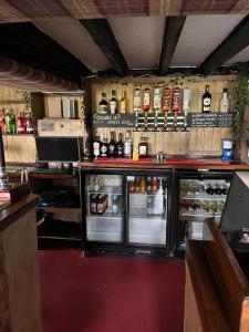 a bar with an open refrigerator and lots of alcohol at The Malt Shovel Inn in Bridgwater