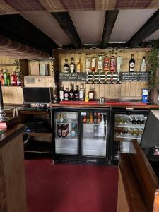 a bar with an open refrigerator and lots of alcohol at The Malt Shovel Inn in Bridgwater