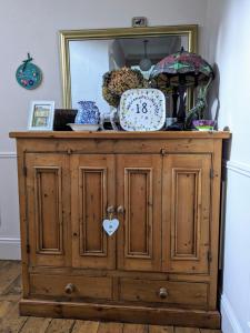 a wooden cabinet with a clock on top of it at Number 18 in Whitby