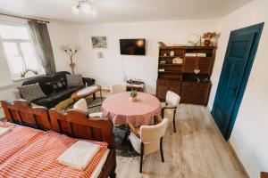 a living room with a table and a couch at DREVENICA in Hrabušice