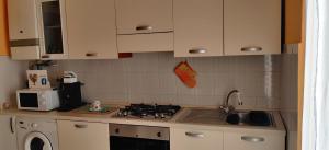 a kitchen with a stove top oven next to a sink at "Casa Sofia" appartamento Raffalda ZONA CLINICA in Piacenza