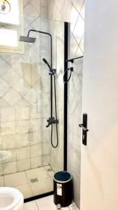 a bathroom with a shower with a toilet and a sink at Smart Entry Apartment in Riyadh