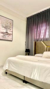 a bedroom with a bed and a purple curtain at Smart Entry Apartment in Riyadh