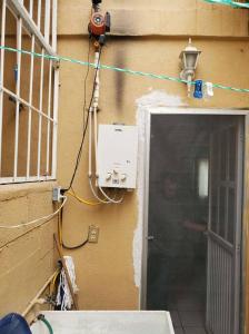 a door to a building with a person standing next to it at Condominio 15, casa 3 Joyas de Ixtapa in Ixtapa