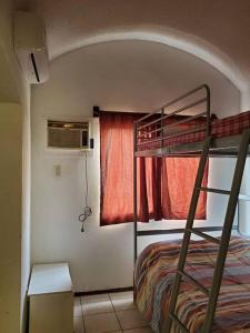 a bedroom with a bunk bed and a window at Condominio 15, casa 3 Joyas de Ixtapa in Ixtapa