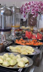 a buffet with plates of food on a table at Hotel Ferrari in Rio do Sul