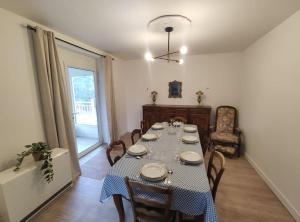 een eetkamer met een tafel en stoelen en een raam bij Chez Madeleine - Maison 11 pers. Parc arboré 3000M² in Lanobre