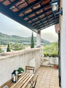 eine Terrasse mit einer Holzbank und einem Tisch in der Unterkunft Casanostra - T3 avec terrasse proche de Cassis in Roquefort-la-Bédoule