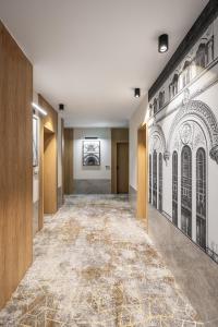 a hallway of a building with a painting on the wall at Hotel Branco Timisoara in Timişoara
