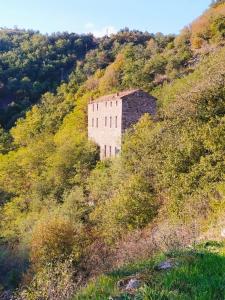 an old building on the side of a hill at Votre gite dans l'ancienne Huilerie de Tourtel in Vernosc-lès-Annonay