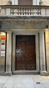 a large wooden door on the side of a building at Plaza Mayor de Salamanca By LixLoft in Salamanca