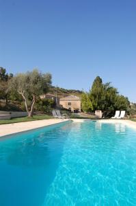 a large swimming pool with blue water at La Casa del Poeta Enna - Pergusa in Enna