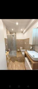 a bathroom with a sink and a toilet at House La Torricella in Vetriolo